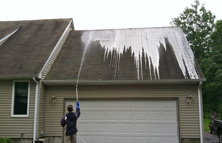 SpringBrook Employee Treating Roof during Roof Cleaning Process