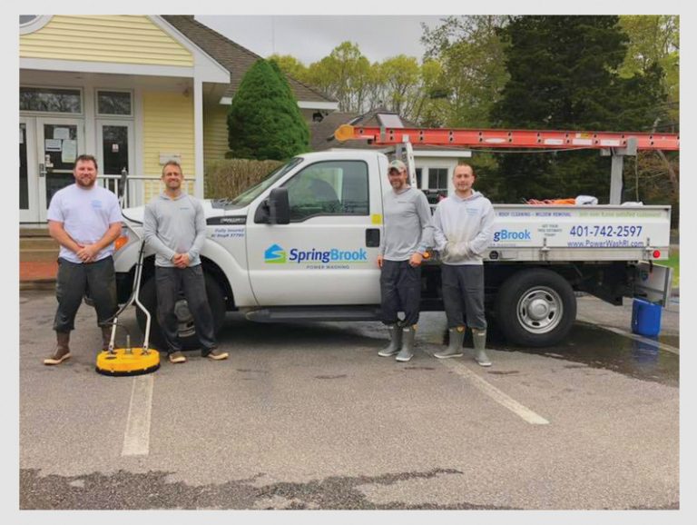 SpringBrook Team Standing in Front their Truck After Washing the Ocean Community Chamber of Commerce Building